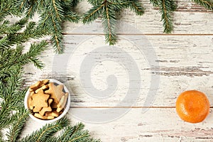 Delicious ginger biscuits. NewYear. Fir branch. One tasty tangerine photo