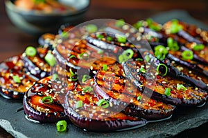 Delicious Glazed Eggplant Slices with Sesame Seeds and Spring Onions on Rustic Wooden Table