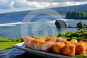 Delicious golden fried fish appetizers on plate with sea view