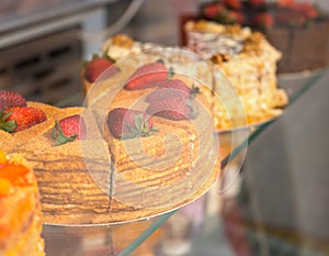 Delicious gourmet cakes in a bakery window