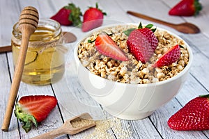 Delicious granola with fresh strawberries in a white plate with