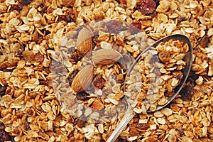 delicious granola muesli with nuts and raising pattern and vintage spoon, flat lay. healthy breakfast concept. cereal meal