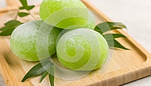 Delicious green mochi on wooden board. Traditional Japanese dessert. Rice cake. Sweet and tasty food