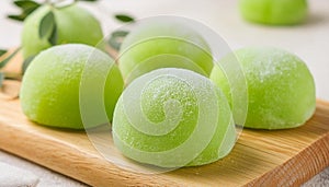 Delicious green mochi on wooden board. Traditional Japanese dessert. Rice cake. Sweet and tasty food