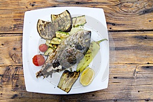 Delicious Grilled bream or dorade fish on wooden background