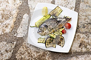 Delicious Grilled bream or dorade fish on wooden background