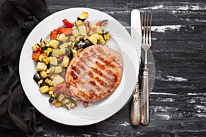 Delicious grilled chicken burgers served with baked vegetables