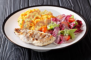 Delicious grilled chicken with garnish of sweet potato and fresh