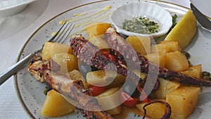 Delicious grilled octopus with potatoes and olive oil