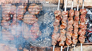 Delicious grilled pork meat in BBQ Barbecue with pork meat. Kebabs on the grill. Close-Up Of Meat On Barbecue Grill With Smoke