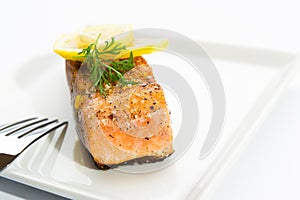 Delicious grilled salmon on a white plate