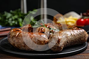 Delicious grilled sausages on table, closeup