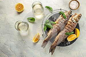 delicious grilled seabass fish with lemon and spices with white wine. banner, menu, recipe place for text, top view