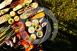 Delicious grilled vegetables on barbecue grill outdoors, top view. Space for text