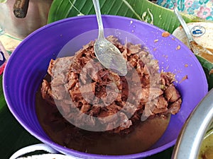 delicious gudeg on purple bowl. gudeg is traditional indonesian food