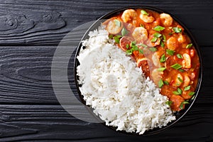 Delicious gumbo with prawns, sausage and rice on a plate. Horiz