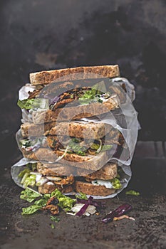 Delicious gyros sandwich in paper bag with salad