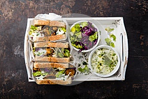 Delicious gyros sandwich in paper bag with salad and tzatziki