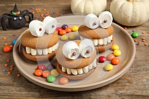 Delicious Halloween themed desserts on wooden table photo