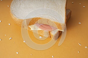 Delicious ham cheese sandwich on orange floor
