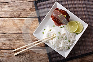 Delicious hambagu steak with gravy and rice vermicelli close-up