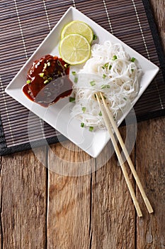 Delicious hambagu steak with gravy and rice vermicelli close-up