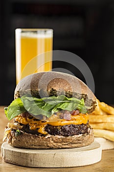 A delicious Hamburguer with some fries and juice