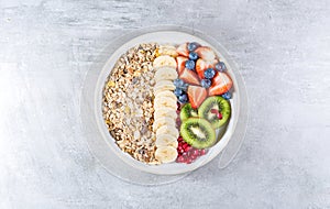 Delicious healthy breakfast of fruit salad with oat muesli. Dietary breakfast