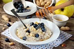 Delicious and healthy breakfast of oatmeal with fresh berries, n