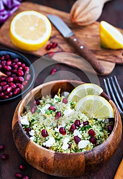 Delicious healthy cous cous salad with herbs, lemon zest, feta c