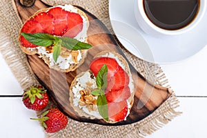 Delicious healthy dietary breakfast: rye bread with cottage cheese and strawberries