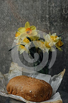 delicious and healthy homemade whole grain bread with honey. place for text. yellow flowers in the background