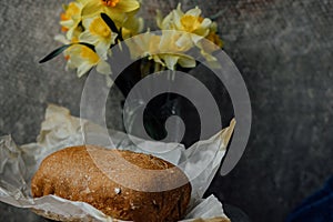 delicious and healthy homemade whole grain bread with honey. place for text. yellow flowers in the background