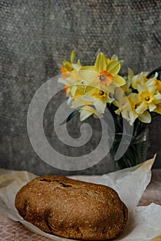 delicious and healthy homemade whole grain bread with honey. place for text. yellow flowers in the background