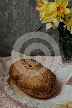 delicious and healthy homemade whole grain bread with honey. place for text. yellow flowers in the background