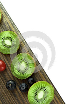 Delicious and healthy kiwi and pineapple fruit on wooden background