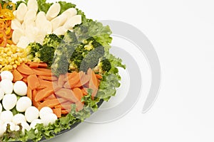 Delicious and healthy lettuce salad with various vegetables and quail egg isolated on white background with copy space