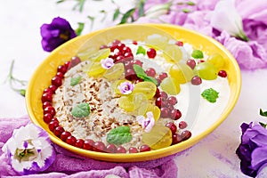 Delicious and healthy oatmeal with grapes, yogurt and cottage cheese