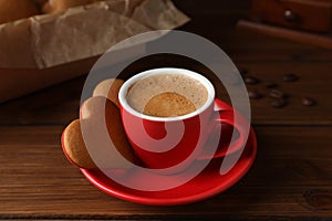 Delicious heart shaped cookies and cup of coffee on wooden table, closeup