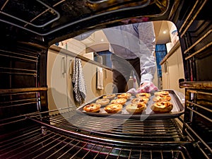 Delicious home baked Portuguese egg tarts out of the oven.