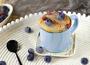 Delicious homemade blueberry muffin mug cake with fresh berries