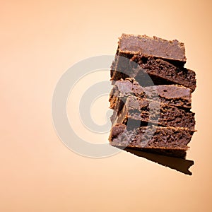 Delicious homemade brownies on a beige background with copy space for text.