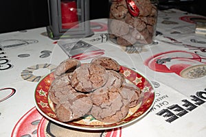 Delicious homemade cacao christmas cookies and a jar and candle in the back