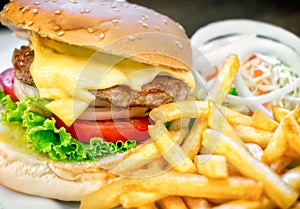 Delicious Homemade Cheeseburger with French Fries and Onion Salad