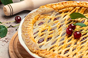 Delicious Homemade Cherry Pie, Flaky Crust, piece on a plate and the whole homemade cherry pie, place for text, top view