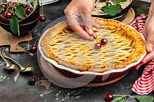 Delicious Homemade Cherry Pie, Flaky Crust, piece on a plate and the whole homemade cherry pie, place for text, top view