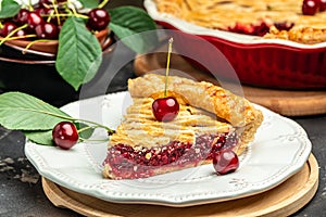 Delicious Homemade Cherry Pie, Flaky Crust, piece on a plate and the whole homemade cherry pie, top view