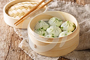 Delicious homemade chinese cuisine Steamed Baozi with bamboo steamer close-up. Horizontal