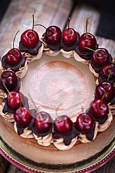 Delicious homemade chocolate cheesecake decorated with fresh cherry
