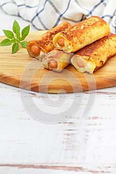 Delicious homemade fried or baked rolls made of wheat bread, sausage and cheese